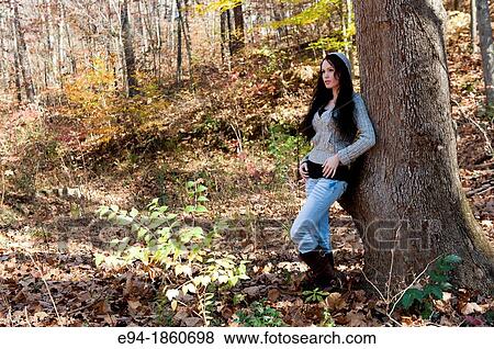 Portrait of 24 year old brunette woman in a back yard in the fall View Large Photo Image Stock Photo - Portrait of 24 year old brunette woman in a back yard in the fall. Fotosearch