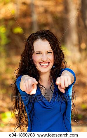 Portrait of 24 year old brunette woman looking directly at the camera and pointing in a forest setting in the fall View Large Photo Image Stock Photo - Portrait of 24 year old brunette woman looking directly at the camera and pointing in a forest setting in the fall. Fotosearch