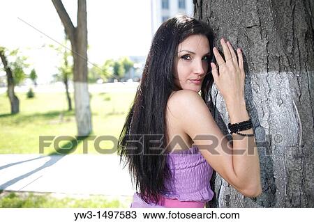 Portrait of 25 year old woman by tree View Large Photo Image Stock Image - Portrait of 25 year old woman by tree. Fotosearch
