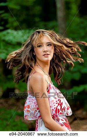 Portrait of a 14 year old brunette girl in a summer dress in an outdoor setting. View Large Photo Image Stock Photo - Portrait of a 14 year old brunette girl in a summer dress in an outdoor setting.. Fotosearch