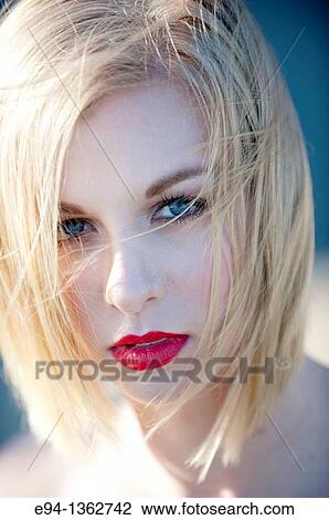 Stock Image - Portrait of a 19 year old blond woman looking directly at camera. Fotosearch