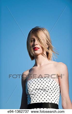 Portrait of a 19 year old blond woman wearing a black and white polka dot dress outdoors View Large Photo Image Stock Photo - Portrait of a 19 year old blond woman wearing a black and white polka dot dress outdoors. Fotosearch