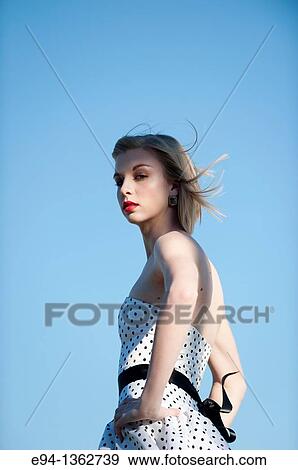 Portrait of a 19 year old blond woman wearing a black and white polka dot dress outdoors View Large Photo Image Stock Photo - Portrait of a 19 year old blond woman wearing a black and white polka dot dress outdoors. Fotosearch
