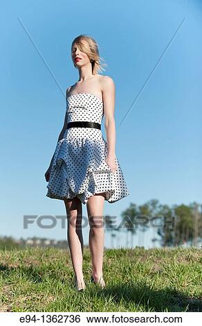 Portrait of a 19 year old blond woman wearing a black and white polka dot dress outdoors View Large Photo Image Stock Photograph - Portrait of a 19 year old blond woman wearing a black and white polka dot dress outdoors. Fotosearch