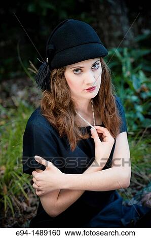 Portrait of a 19 year old brunette woman wearing a hat in a garden setting. View Large Photo Image Stock Image - Portrait of a 19 year old brunette woman wearing a hat in a garden setting.. Fotosearch
