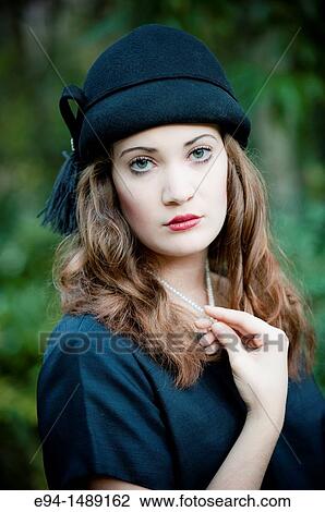Portrait of a 19 year old brunette woman wearing a hat in a garden setting. View Large Photo Image Stock Image - Portrait of a 19 year old brunette woman wearing a hat in a garden setting.. Fotosearch