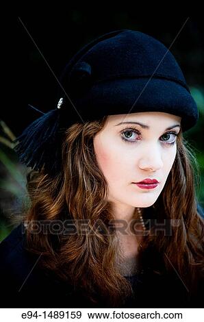 Portrait of a 19 year old brunette woman wearing a hat in a garden setting. View Large Photo Image Stock Photo - Portrait of a 19 year old brunette woman wearing a hat in a garden setting.. Fotosearch