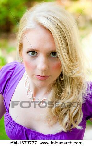 Portrait of a 20 year old blond woman in a fuschia dress outdoors looking at the camera View Large Photo Image Stock Photo - Portrait of a 20 year old blond woman in a fuschia dress outdoors looking at the camera. Fotosearch