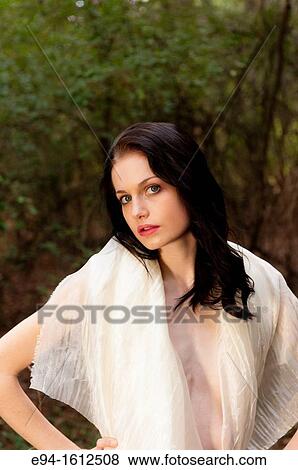 Portrait of a 20 year old brunettte woman wrapped in white fabric in a forest setting View Large Photo Image Stock Photo - Portrait of a 20 year old brunettte woman wrapped in white fabric in a forest setting. Fotosearch
