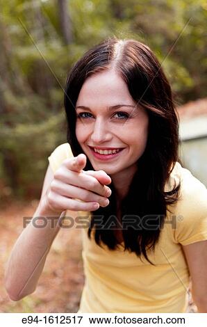 Portrait of a 20 year old brunettte woman laughing and pointing her finger at the camera View Large Photo Image Stock Photo - Portrait of a 20 year old brunettte woman laughing and pointing her finger at the camera. Fotosearch