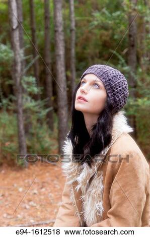 Portrait of a 20 year old brunettte woman wearing a knit hat and a leather coat in a forest View Large Photo Image Stock Photo - Portrait of a 20 year old brunettte woman wearing a knit hat and a leather coat in a forest. Fotosearch