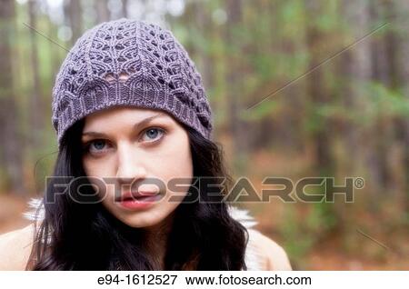 Portrait of a 20 year old brunettte woman wearing a knit hat outdoors View Large Photo Image Stock Photo - Portrait of a 20 year old brunettte woman wearing a knit hat outdoors. Fotosearch