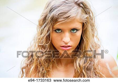Portrait of a 20 year old woman with long curly blond hair and bare shoulders looking directly at the camera View Large Photo Image Stock Image - Portrait of a 20 year old woman with long curly blond hair and bare shoulders looking directly at the camera. Fotosearch