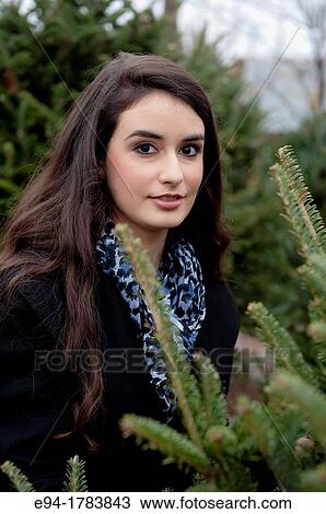 Portrait of a 21 year old brunette woman shoopping in a plant nursery View Large Photo Image Stock Image - Portrait of a 21 year old brunette woman shoopping in a plant nursery. Fotosearch