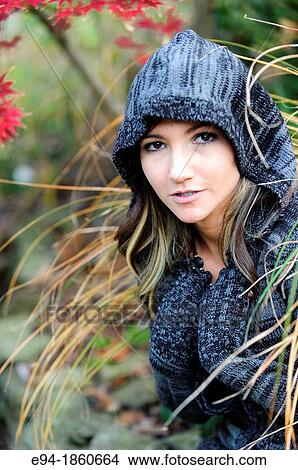 Portrait of a 21 year old woman in a garden setting in the fall View Large Photo Image Picture - Portrait of a 21 year old woman in a garden setting in the fall. Fotosearch