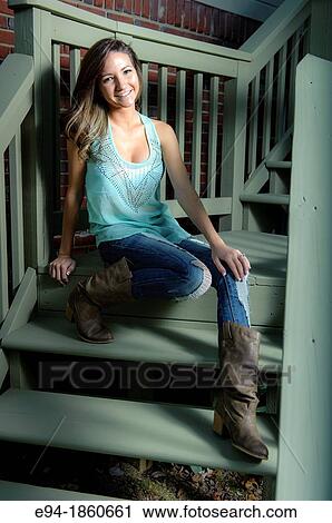 Portrait of a 21 year old woman sitting on porch steps outdoors View Large Photo Image Stock Image - Portrait of a 21 year old woman sitting on porch steps outdoors. Fotosearch