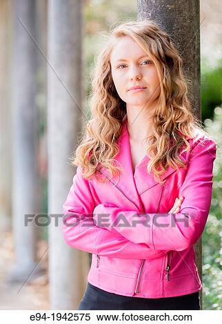 Portrait of a 22 year old blond woman outdoors wearing a pink jacket. View Large Photo Image Stock Photography - Portrait of a 22 year old blond woman outdoors wearing a pink jacket.. Fotosearch