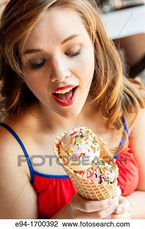 Portrait of a 22 year old brunette woman outdoors with an ice cream cone View Large Photo Image Stock Image - Portrait of a 22 year old brunette woman outdoors with an ice cream cone. Fotosearch