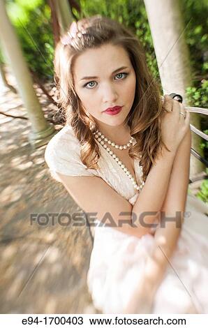 Stock Image - Portrait of a 22 year old brunette woman outdoors. Fotosearch
