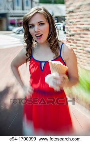 Portrait of a 22 year old brunette woman outdoors with an ice cream cone View Large Photo Image Stock Photo - Portrait of a 22 year old brunette woman outdoors with an ice cream cone. Fotosearch