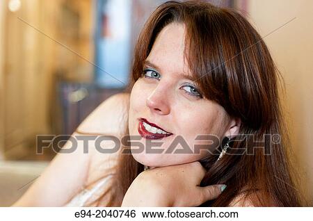 Portrait of a 22 year old brunette woman looking at the camera, inside. View Large Photo Image Stock Photograph - Portrait of a 22 year old brunette woman looking at the camera, inside.. Fotosearch
