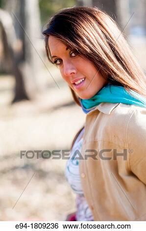 Portrait of a 23 year old brunette woman in a casual setting outdoors View Large Photo Image Stock Photograph - Portrait of a 23 year old brunette woman in a casual setting outdoors. Fotosearch