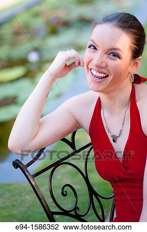 Portrait of a 24 year old brunette woman in a red dress near trees View Large Photo Image Stock Image - Portrait of a 24 year old brunette woman in a red dress near trees. Fotosearch