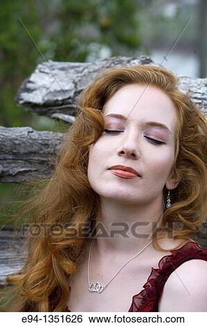 Portrait of a 28 year old redheaded woman eyes closed with face looking up. View Large Photo Image Stock Photograph - Portrait of a 28 year old redheaded woman eyes closed with face looking up.. Fotosearch