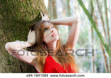 Portrait of a 30 year old redheaded woman outdoors View Large Photo Image Picture - Portrait of a 30 year old redheaded woman outdoors. Fotosearch
