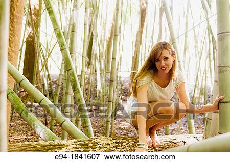 Portrait of a 30 year old redheaded woman wearing a white dress in a bamboo forest View Large Photo Image Stock Photo - Portrait of a 30 year old redheaded woman wearing a white dress in a bamboo forest. Fotosearch