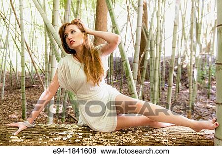 Portrait of a 30 year old redheaded woman wearing a white dress in a bamboo forest View Large Photo Image Stock Photo - Portrait of a 30 year old redheaded woman wearing a white dress in a bamboo forest. Fotosearch