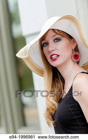 Portrait of a 31 year old red headed woman wearing a big hat in an urban setting. View Large Photo Image Stock Image - Portrait of a 31 year old red headed woman wearing a big hat in an urban setting.. Fotosearch