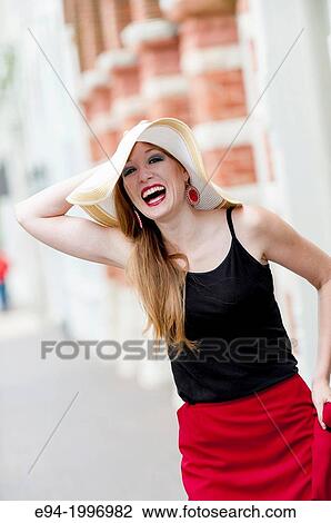 Portrait of a 31 year old red headed woman wearing a big hat in an urban setting. View Large Photo Image Stock Image - Portrait of a 31 year old red headed woman wearing a big hat in an urban setting.. Fotosearch