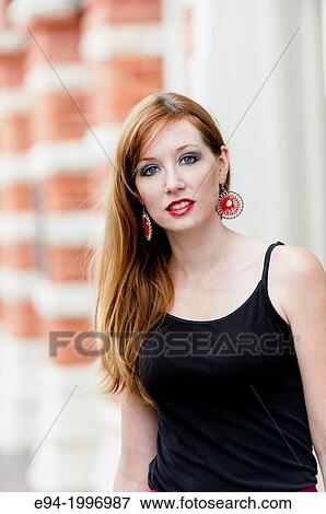 Portrait of a 31 year old red headed woman in an urban setting. View Large Photo Image Stock Photo - Portrait of a 31 year old red headed woman in an urban setting.. Fotosearch