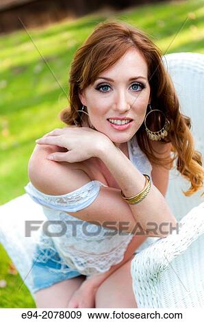 Portrait of a 31 year old redhead woman smiling at the camera outdoors. View Large Photo Image Stock Photo - Portrait of a 31 year old redhead woman smiling at the camera outdoors.. Fotosearch