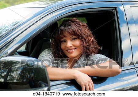 Portrait of a 32 year old brunette woman looking out of the driver's side window of a car View Large Photo Image Stock Photo - Portrait of a 32 year old brunette woman looking out of the driver's side window of a car. Fotosearch