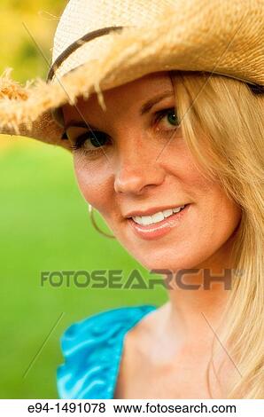 Portrait of a 35 year old blond woman in casual blue dress with a straw hat, outdoors in a country setting. View Large Photo Image Stock Photo - Portrait of a 35 year old blond woman in casual blue dress with a straw hat, outdoors in a country setting.. Fotosearch