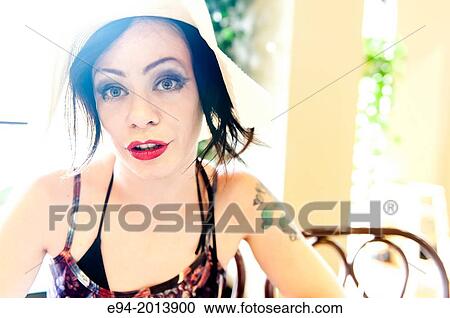 Portrait of a 35 year old brunette woman wearing a hat in a cafe. View Large Photo Image Stock Image - Portrait of a 35 year old brunette woman wearing a hat in a cafe.. Fotosearch