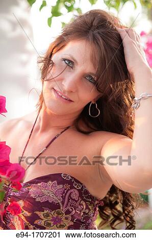 Portrait of a 39 year old brunette woman in casual clothing in a garden setting View Large Photo Image Stock Image - Portrait of a 39 year old brunette woman in casual clothing in a garden setting. Fotosearch