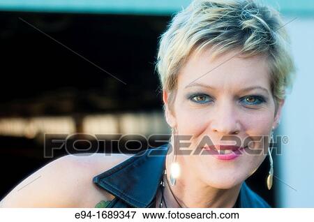 Portrait of a 41 year old blond woman smiling at the camera View Large Photo Image Stock Photo - Portrait of a 41 year old blond woman smiling at the camera. Fotosearch