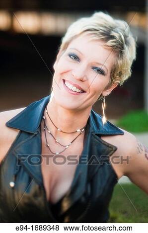 Portrait of a 41 year old blond woman smiling at the camera View Large Photo Image Stock Photo - Portrait of a 41 year old blond woman smiling at the camera. Fotosearch