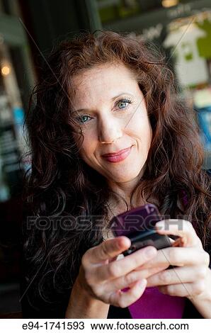Portrait Of A 42 Year Old Woman With Long Curly Black Hair