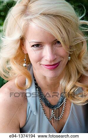 Portrait of a 44 year old blond woman, outdoors View Large Photo Image Picture - Portrait of a 44 year old blond woman, outdoors. Fotosearch