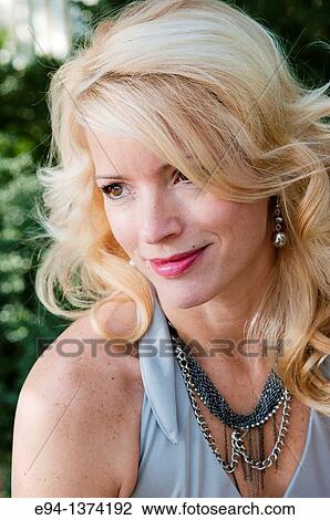 Portrait of a 44 year old blond woman, outdoors View Large Photo Image Stock Image - Portrait of a 44 year old blond woman, outdoors. Fotosearch