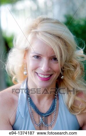 Portrait of a 44 year old blond woman, outdoors View Large Photo Image Stock Photo - Portrait of a 44 year old blond woman, outdoors. Fotosearch