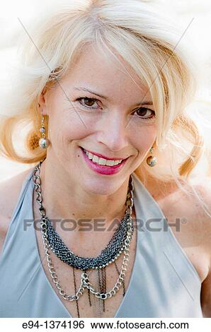 Portrait of a 44 year old blond woman, outdoors View Large Photo Image Stock Photograph - Portrait of a 44 year old blond woman, outdoors. Fotosearch
