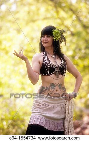 Portrait of a 45 year old brunette woman in an exotic costume outdoors View Large Photo Image Picture - Portrait of a 45 year old brunette woman in an exotic costume outdoors. Fotosearch