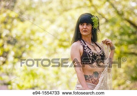 Portrait of a 45 year old brunette woman in an exotic costume outdoors View Large Photo Image Stock Image - Portrait of a 45 year old brunette woman in an exotic costume outdoors. Fotosearch