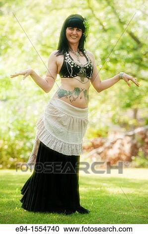 Portrait of a 45 year old brunette woman in an exotic costume outdoors View Large Photo Image Stock Image - Portrait of a 45 year old brunette woman in an exotic costume outdoors. Fotosearch
