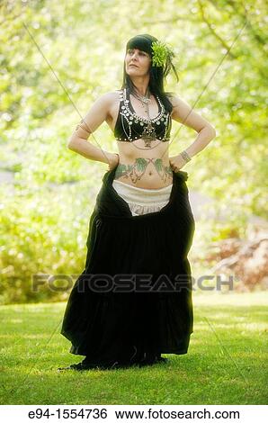 Portrait of a 45 year old brunette woman in an exotic costume outdoors View Large Photo Image Stock Photograph - Portrait of a 45 year old brunette woman in an exotic costume outdoors. Fotosearch